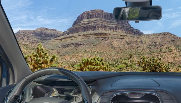 Looking through a car windshield with view of Spirit Mountain and joshua trees, Grand Canyon, Arizona, USA