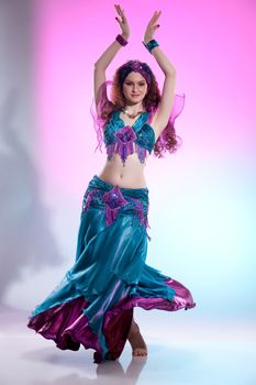 Young woman dressed in a traditional eastern dancing clothing