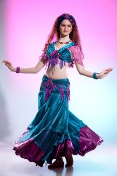 Young woman dressed in a traditional eastern dancing clothing