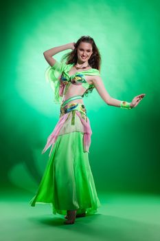 Young woman dressed in a traditional eastern dancing clothing