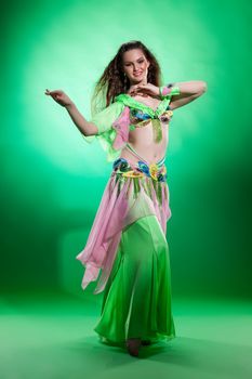 Young woman dressed in a traditional eastern dancing clothing