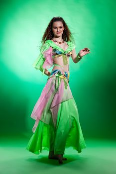 Young woman dressed in a traditional eastern dancing clothing