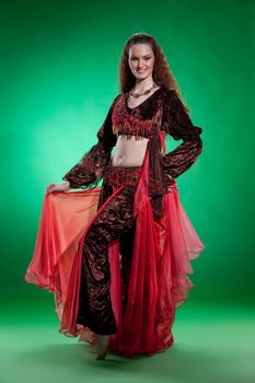 Young woman dressed in a traditional eastern dancing clothing