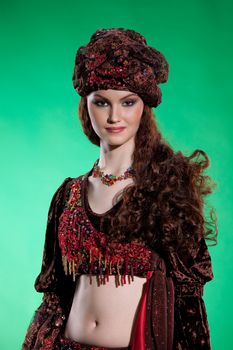 Young woman dressed in a traditional eastern dancing clothing