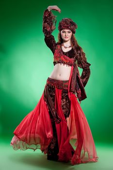 Young woman dressed in a traditional eastern dancing clothing