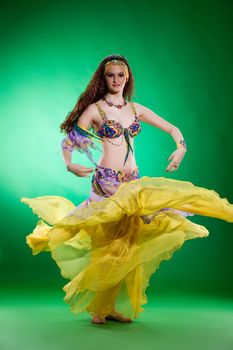 Young woman dressed in a traditional eastern dancing clothing