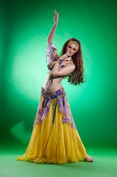 Young woman dressed in a traditional eastern dancing clothing