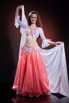 Young woman dressed in a traditional eastern dancing clothing