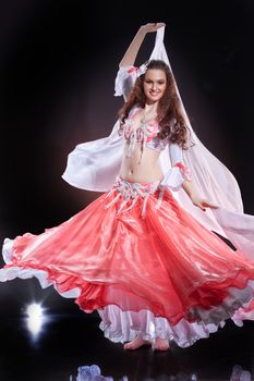 Young woman dressed in a traditional eastern dancing clothing