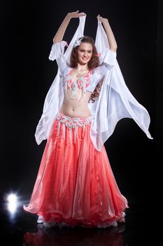 Young woman dressed in a traditional eastern dancing clothing