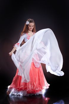 Young woman dressed in a traditional eastern dancing clothing