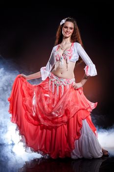 Young woman dressed in a traditional eastern dancing clothing