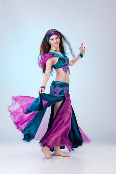 Young beautiful woman dressed in eastern style on isolated background