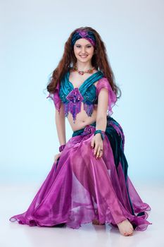 Young beautiful woman dressed in eastern style on isolated background