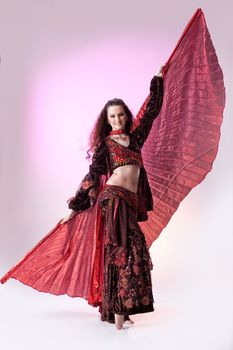 Young woman dressed in a traditional eastern dancing clothing