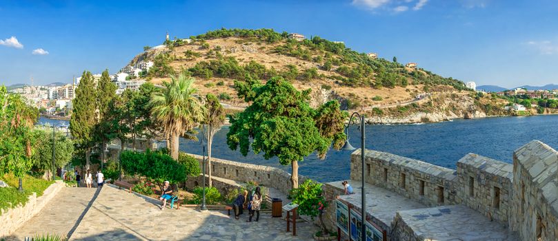 Kusadasi, Turkey – 07.18.2019.  Kusadasi castle in Turkey and pleasure boat parking on a summer evening