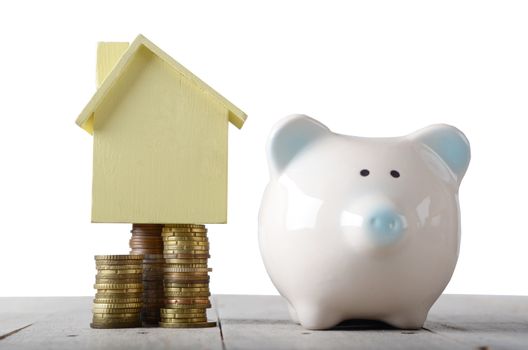 Piggy bank and model house on cash. Savings plans for housing ,financial concept.