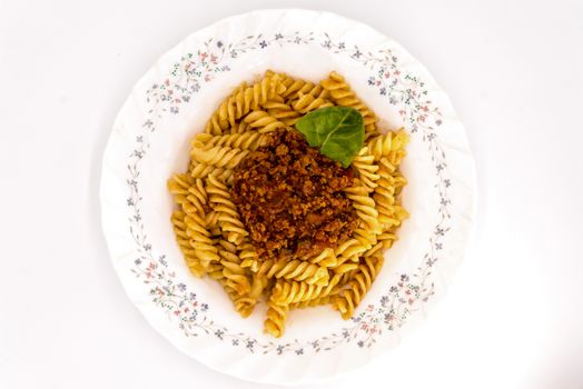 Spirelli with Bolognese Sauce on a white background