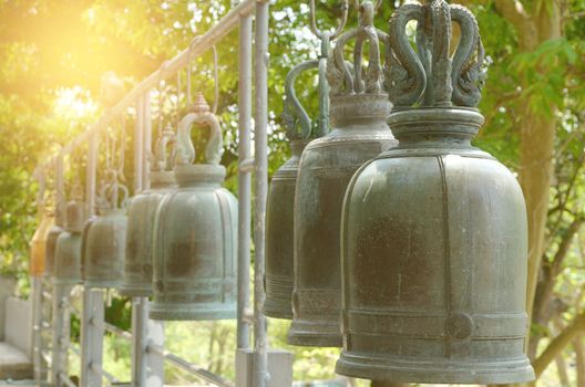 Buddhist bells with wishes in sunlight