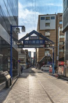 Blue metal entrance gate of the shopping street from the west exit of Kanda Station on the Yamanote Line. The street extends over 300 meters and has no less than 100 shops.