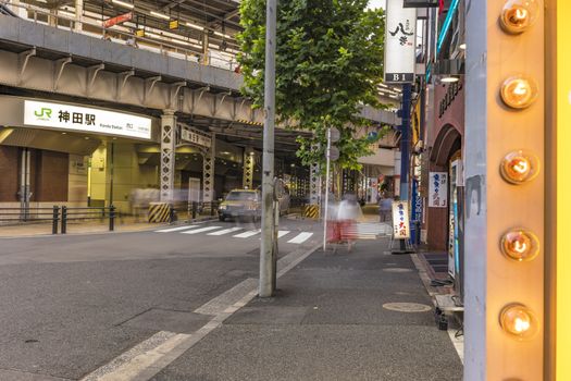 Underpass with metal pillar and neon signs at the west entrance of Kanda Station on the Yamanote Line. The street extends over 300 meters and has no less than 100 shops.