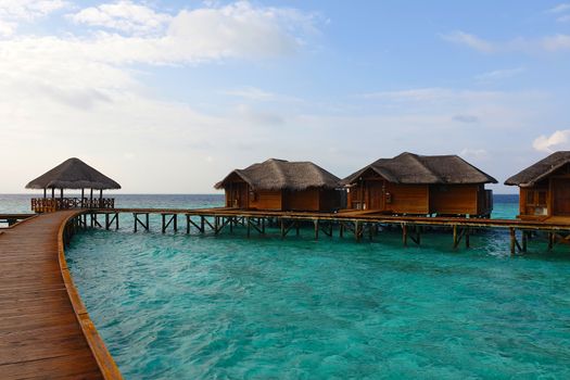 Wooden houses on the water near the shore.