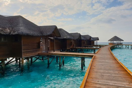 Wooden houses on the water near the shore.