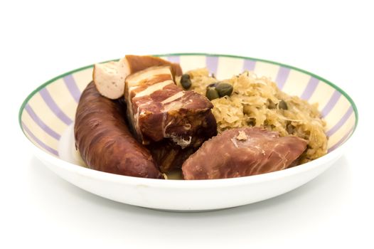 Central and Eastern European cuisine sauerkraut - riesling sauerkraut with bacon and sausage on a white background