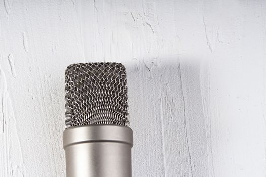 Microphone on lay on a texture background with a light
