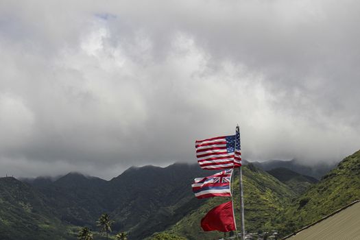USA flag at Hawaii green hills on a cloudy day