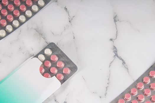Birth control pills on a marble background