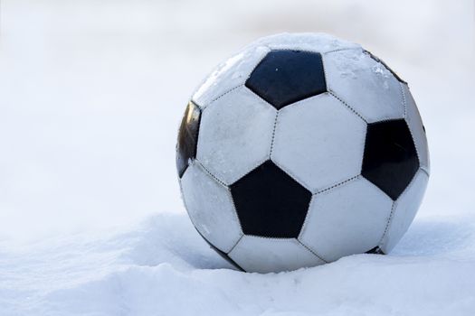 Football, soccer ball on snow