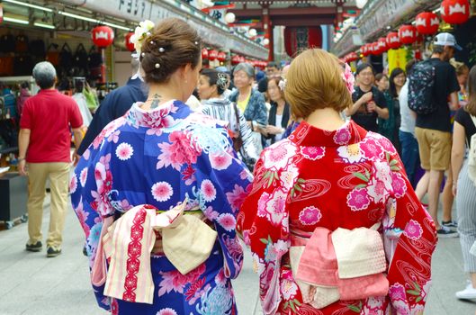 Young girl wearing Japanese kimono standing in front of Sensoji Temple in Tokyo, Japan. Kimono is a Japanese traditional garment. 