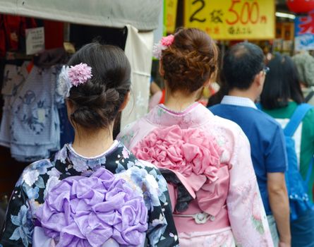 Young girl wearing Japanese kimono standing in front of Sensoji Temple in Tokyo, Japan. Kimono is a Japanese traditional garment. 