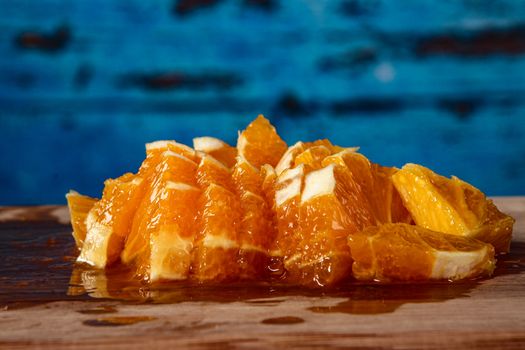 close up pictures of raw healthy food and smoothies. Oranges with blue wood background
