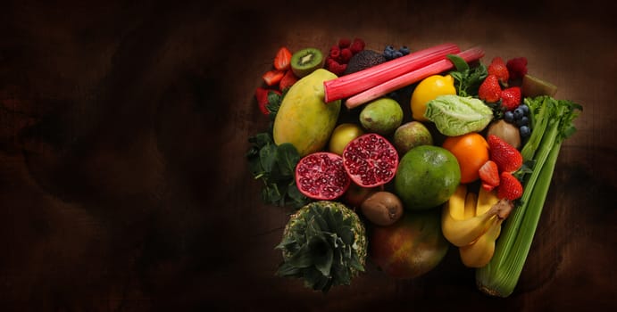 close up of raw healthy food and fruit on a wood board with copy space.