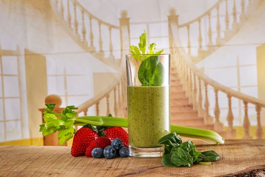 close up of a glass with smoothy. pictures of raw healthy food with green vegetable and strawberries