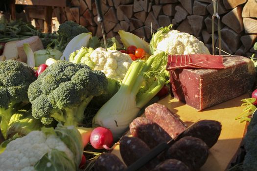 a good meal with wine. Shot from above with copy space and oval plates and a glass of wine with wood logs as background