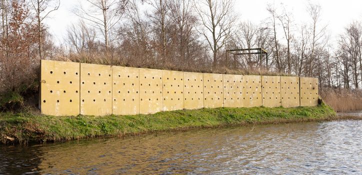 Wall with holes, nests for swallows in the Netherlands