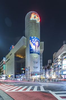 TOKYO, JAPAN - August 21 2018: Futuristic architecture with center tower on Shibuya Crossing Intersection in front of Shibuya Station in a summer evening.