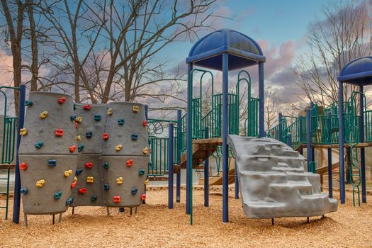 A children's playground with a climbing wall