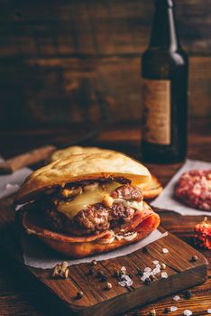 Cheeseburger on Cutting Board with Bottle of Craft Beer.