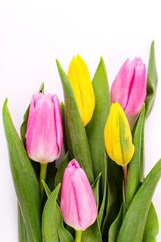 Bouquet of yellow and pink tulips isolated on white background with clipping path. Valentine's Day and Mother's Day background. Top view.