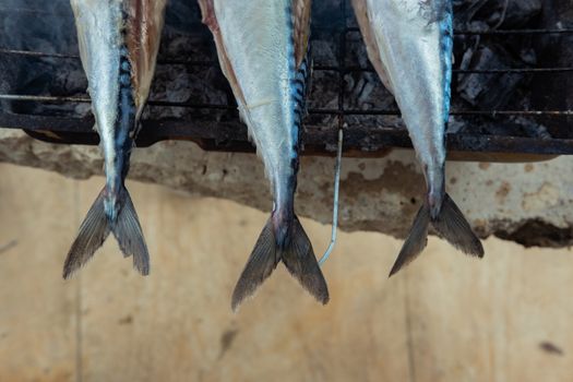Tails of grilled fishes. Close-up from above.
