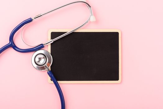 Doctor's Day concept, flat lay top view, equipment medical red heart stethoscope on pink background, care patient in hospital with black board copy space for text