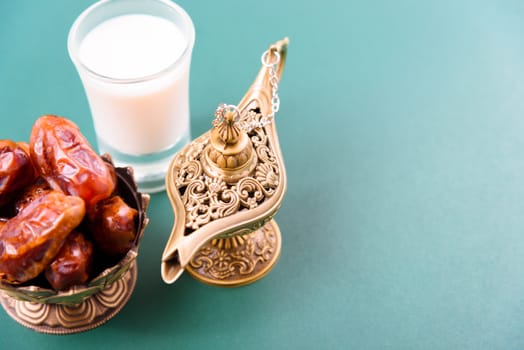Ramadan, Dates in golden bowl, Milk, arabian Aladdin golden lamp vintage style on black green background