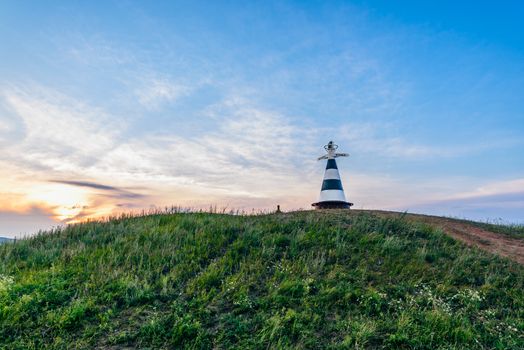 Beacon with the pointer 'Volga' and 'Kama' rivers on the hill in sunset light