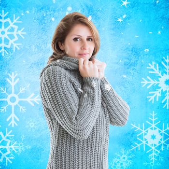 Pretty girl in jumper against blue snow flake pattern design