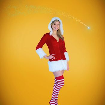 Pretty girl smiling in santa outfit against yellow background with vignette