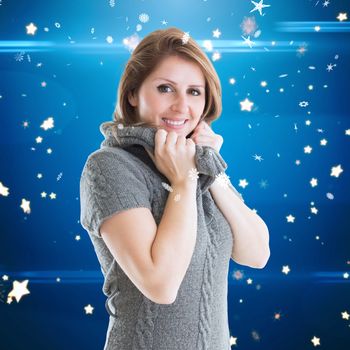 Pretty girl in jumper against bright star pattern on blue